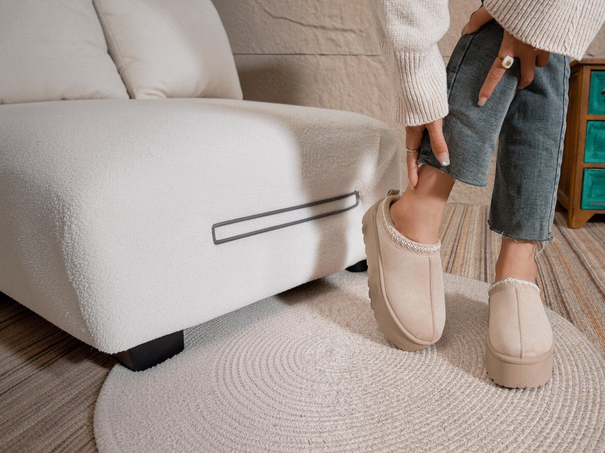 BROCK ERYNN beige cocooning ankle boots with geometric trim and thick platform sole worn in a cozy living room
