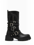 BROCK ERYNN black rock-style flat boots with metallic buckles, adjustable straps, and a thick lug sole.