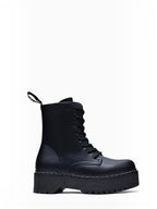 BROCK ERYNN black combat boots with platform lug sole, lace-up front, and white contrast stitching.