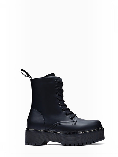 BROCK ERYNN black combat boots with platform lug sole, lace-up front, and white contrast stitching.