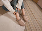 BROCK ERYNN taupe cocooning ankle boots with geometric patterned trim and thick cushioned soles worn by a woman
