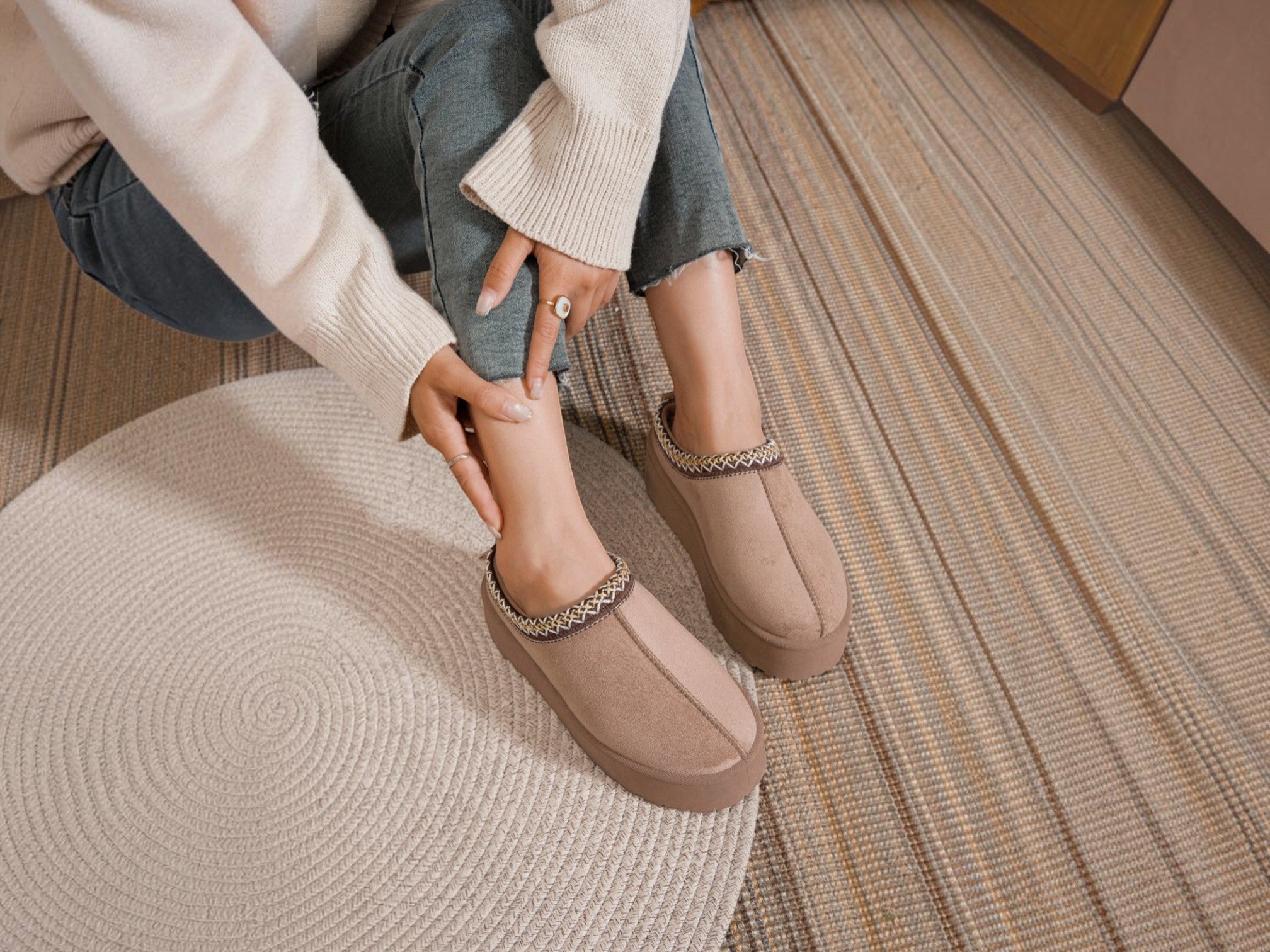BROCK ERYNN taupe cocooning ankle boots with geometric patterned trim and thick cushioned soles worn by a woman