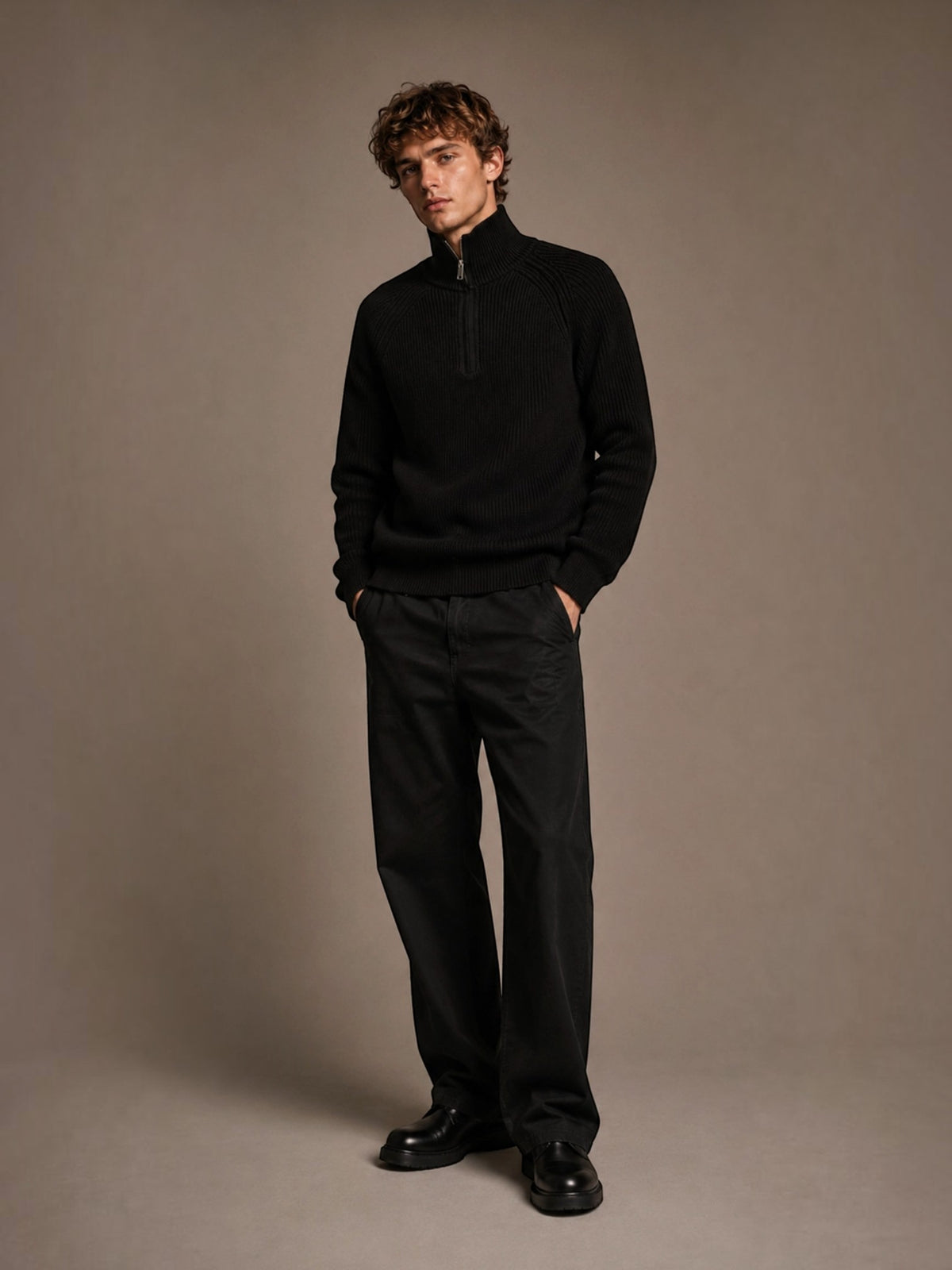 BROCK FIVE EVER black ribbed knit sweater with a mock neck and half-zip, worn by a man with dark trousers.