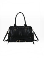 BROCK GALLANTRY Le Vespera black synthetic bowling bag with vintage patina, gold hardware, and decorative buckles.