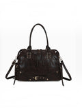 BROCK GALLANTRY Le Vespera A4 bowling bag in dark brown faux leather with gold hardware, buckles, and eyelet details.