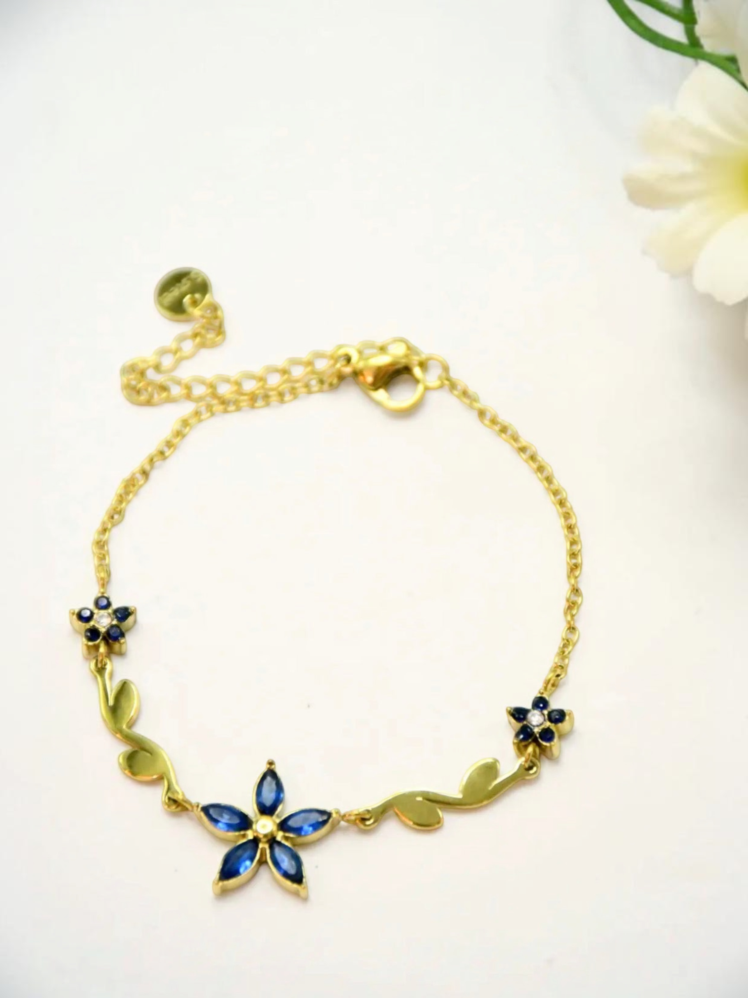 BROCK gold stainless steel chain bracelet with blue floral rhinestone motifs and adjustable extension chain