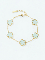 BROCK gold stainless steel bracelet featuring five light green flower charms with beaded edges