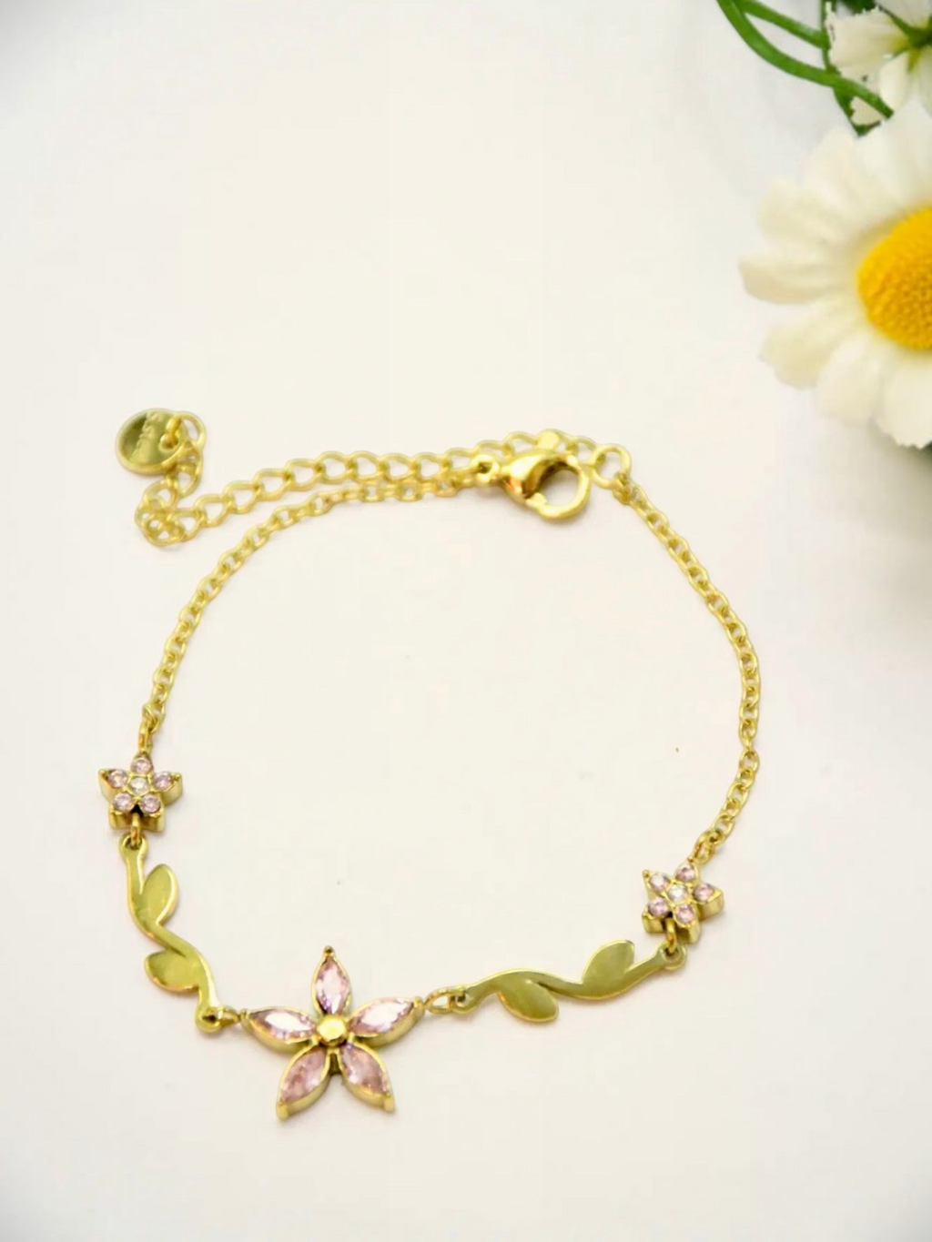BROCK gold stainless steel chain bracelet with pink rhinestone flower and leaf charms and an extension chain