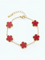 BROCK gold-tone stainless steel bracelet featuring five red flower charms with delicate beaded edges