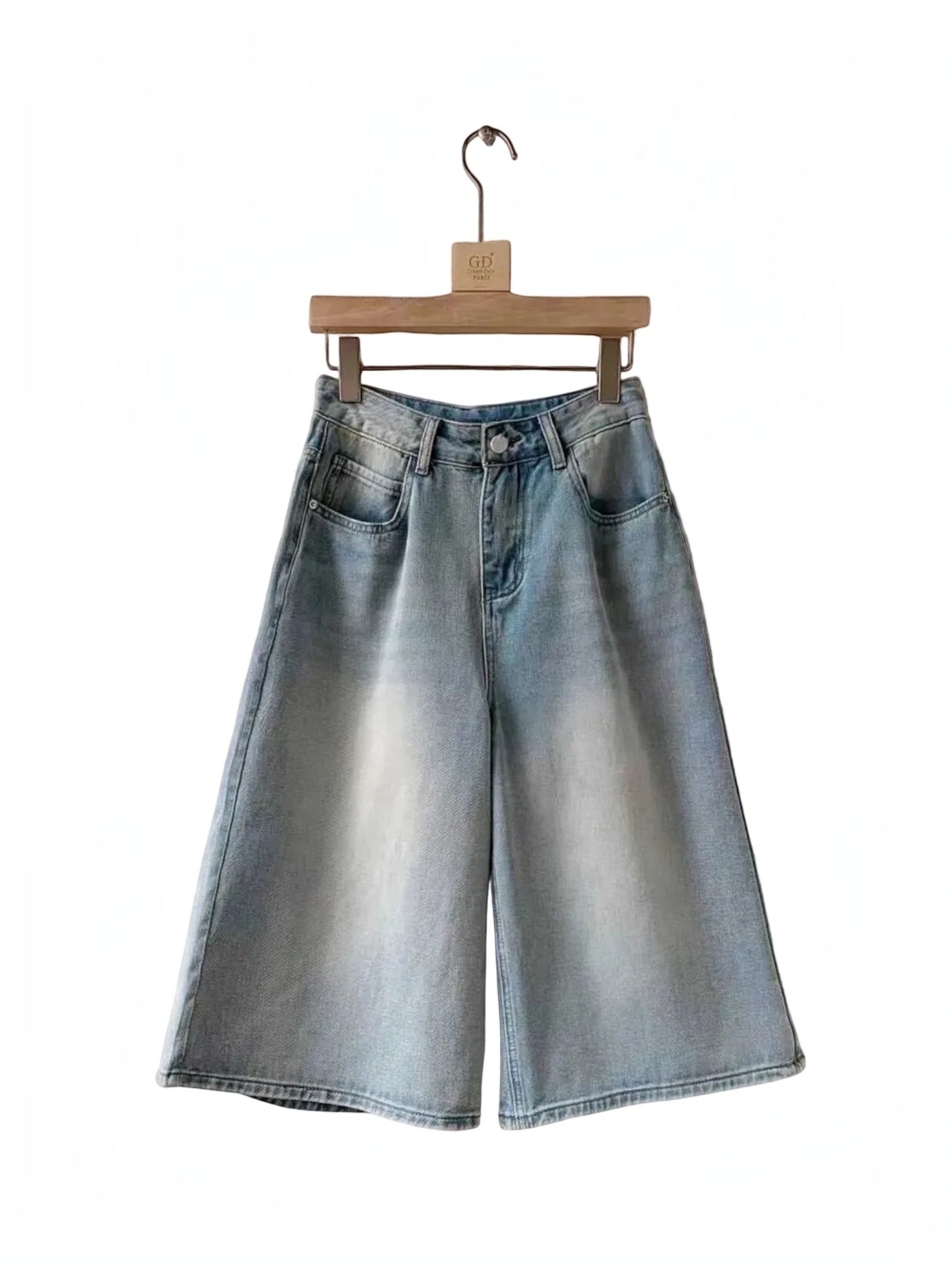 BROCK Golden Days high-waisted light wash denim skort with flared cut and stitched details on a wooden hanger