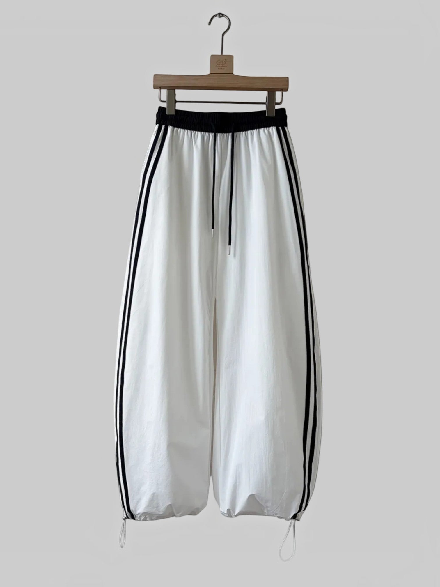 BROCK Golden days wide-leg viscose trousers in white with black side stripes, elastic waist, and adjustable cuffs.
