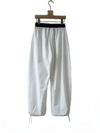 BROCK Golden days white wide-leg viscose trousers with a black elastic waistband and adjustable leg cuffs.