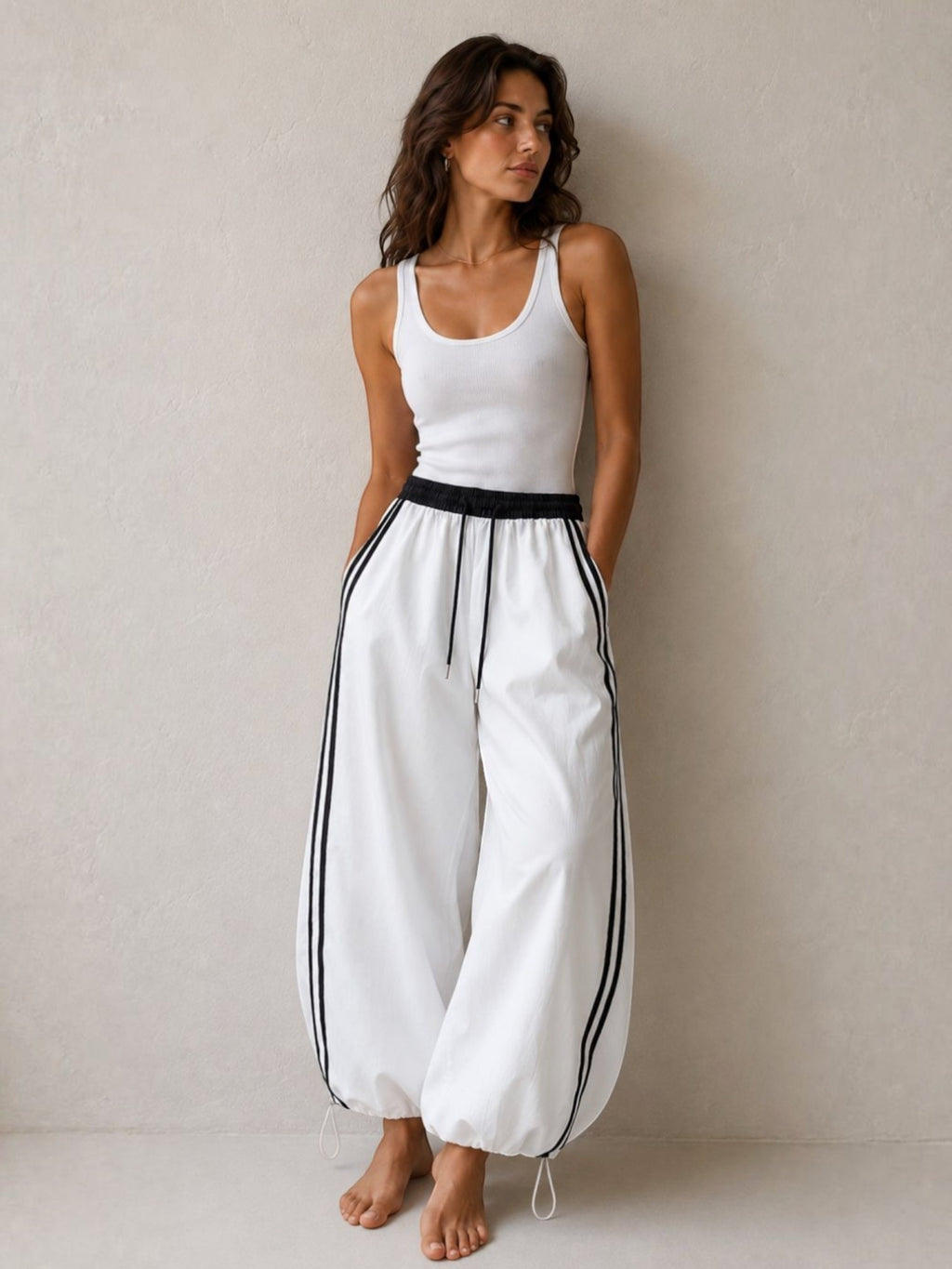BROCK Golden days wide-leg viscose trousers in white with black side stripes, elastic waist, and adjustable cuffs.