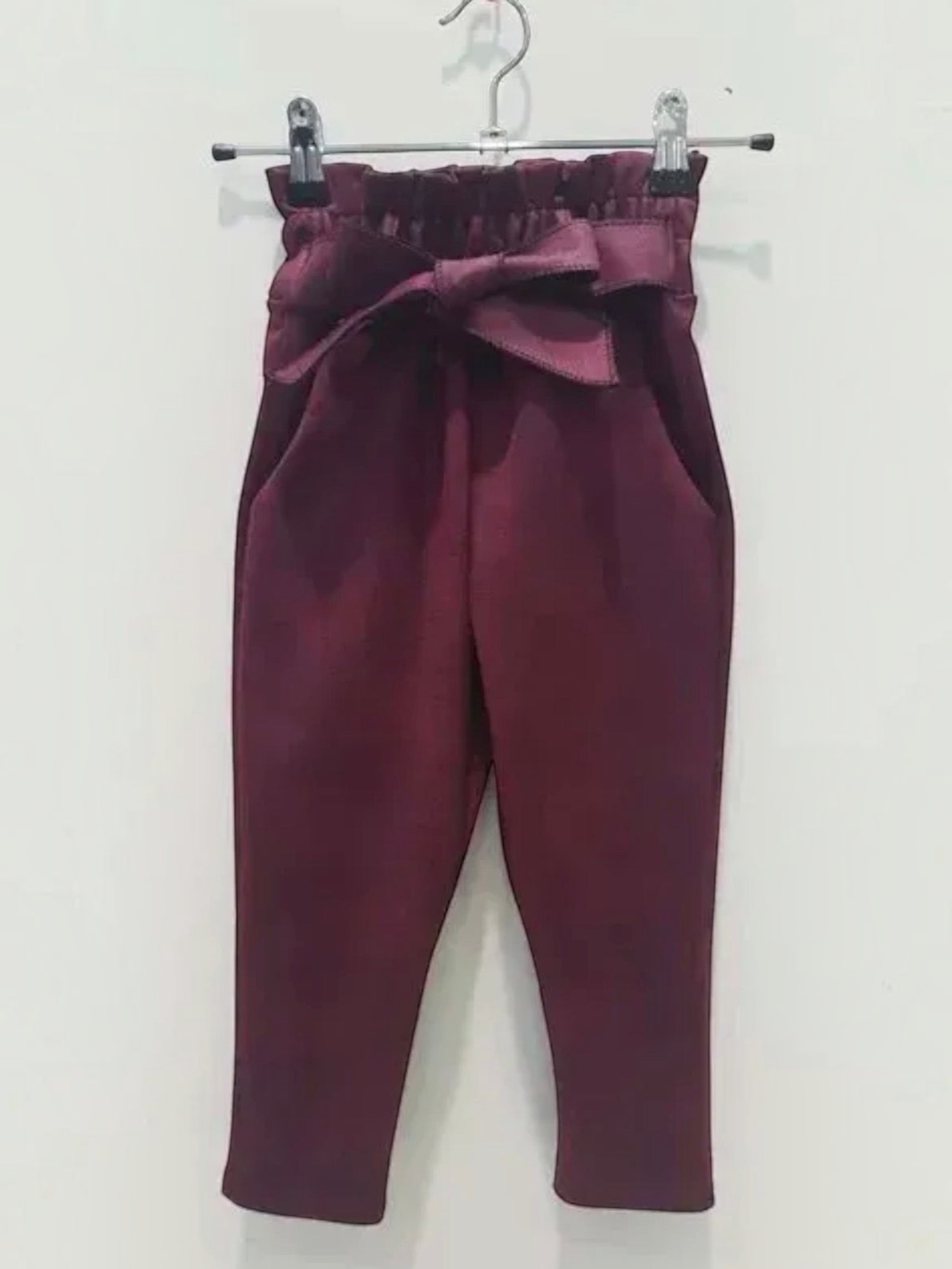 BROCK GRASSTAR children's burgundy trousers with a high paperbag waist, tie belt, and comfortable stretch fit.