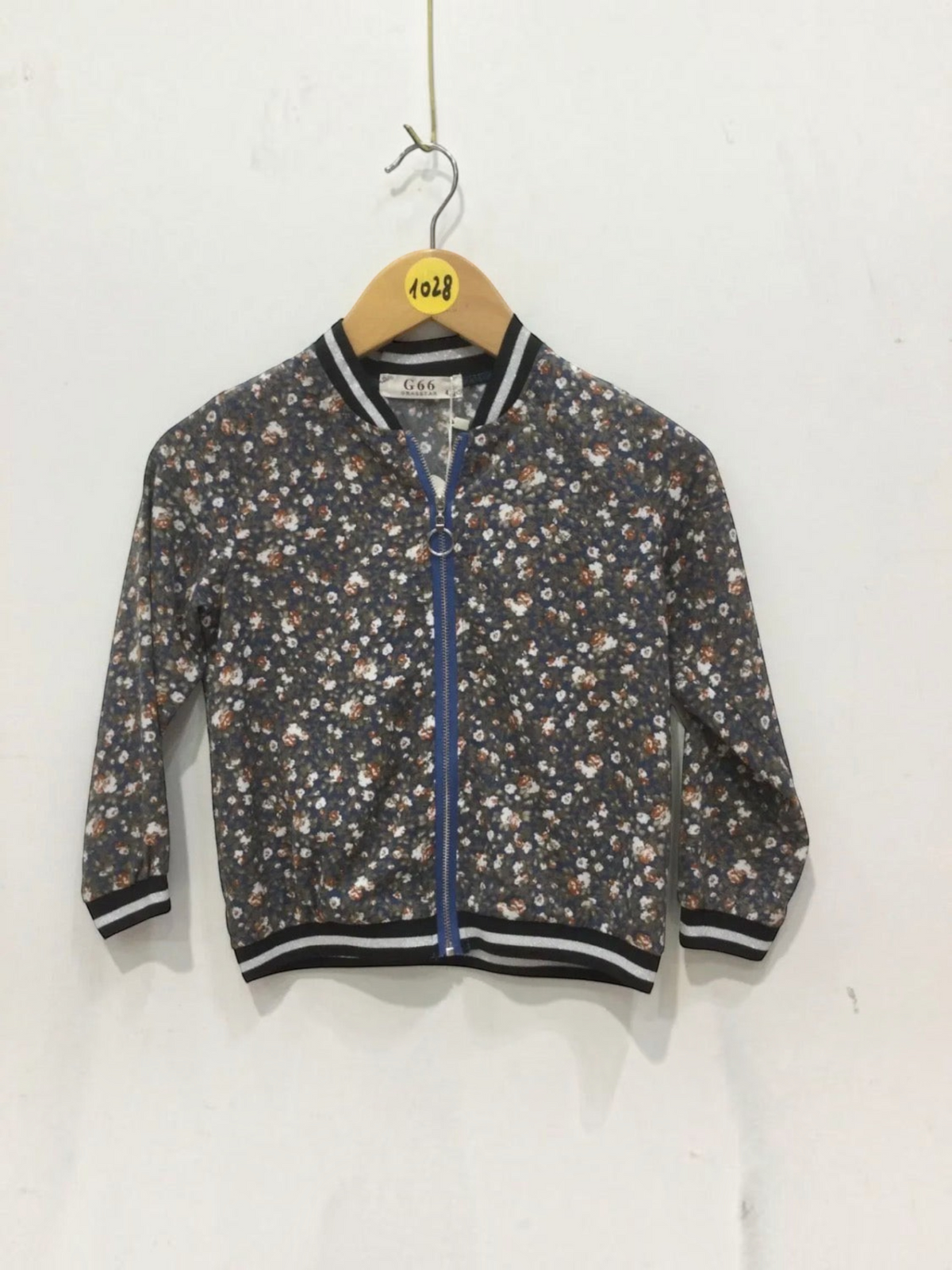 BROCK GRASSTAR children's floral bomber jacket with a blue zipper and striped ribbed cuffs and hem.