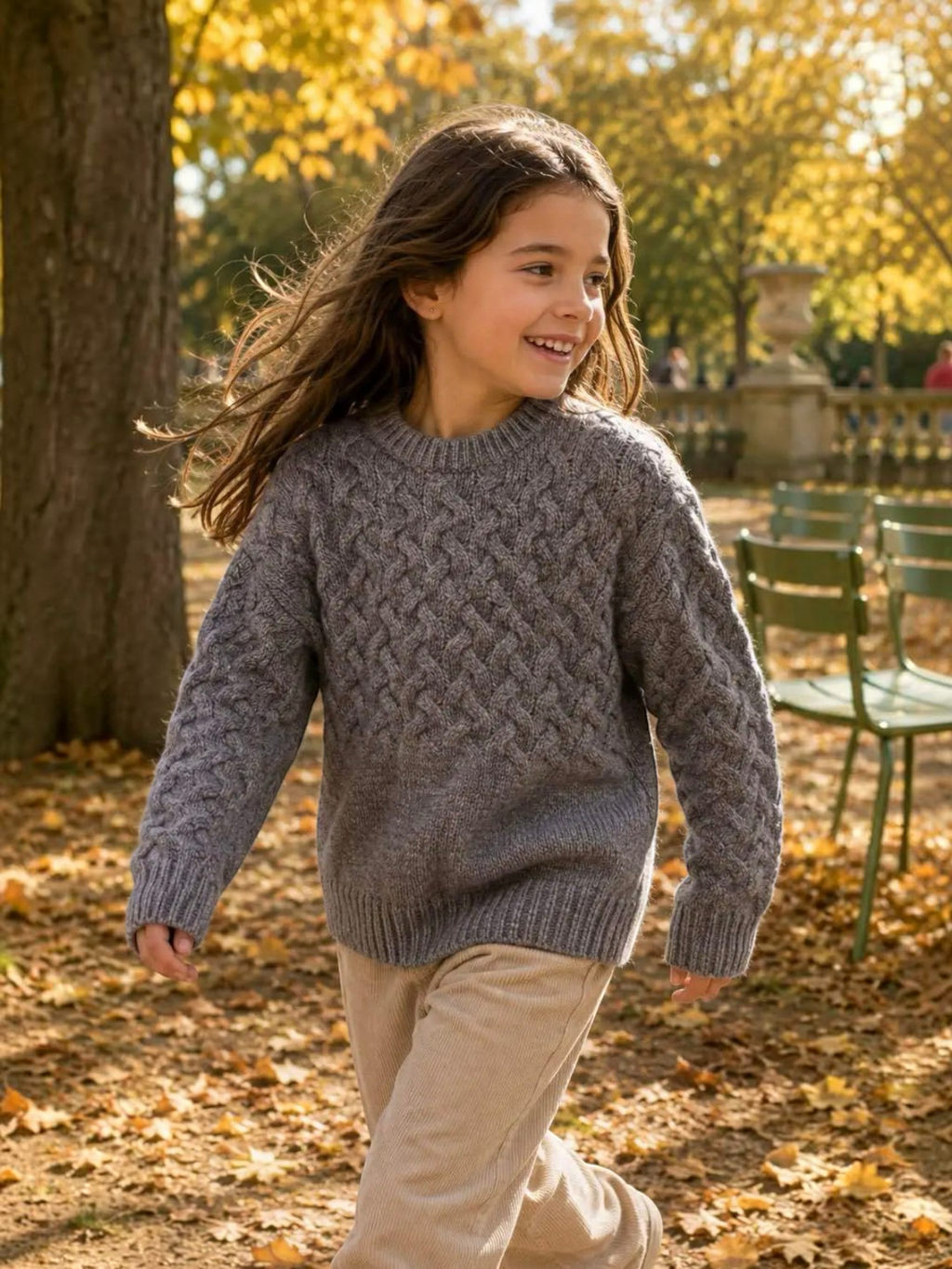 BROCK GRASSTAR child wearing a grey cable-knit crew neck sweater with ribbed cuffs in an autumn park setting