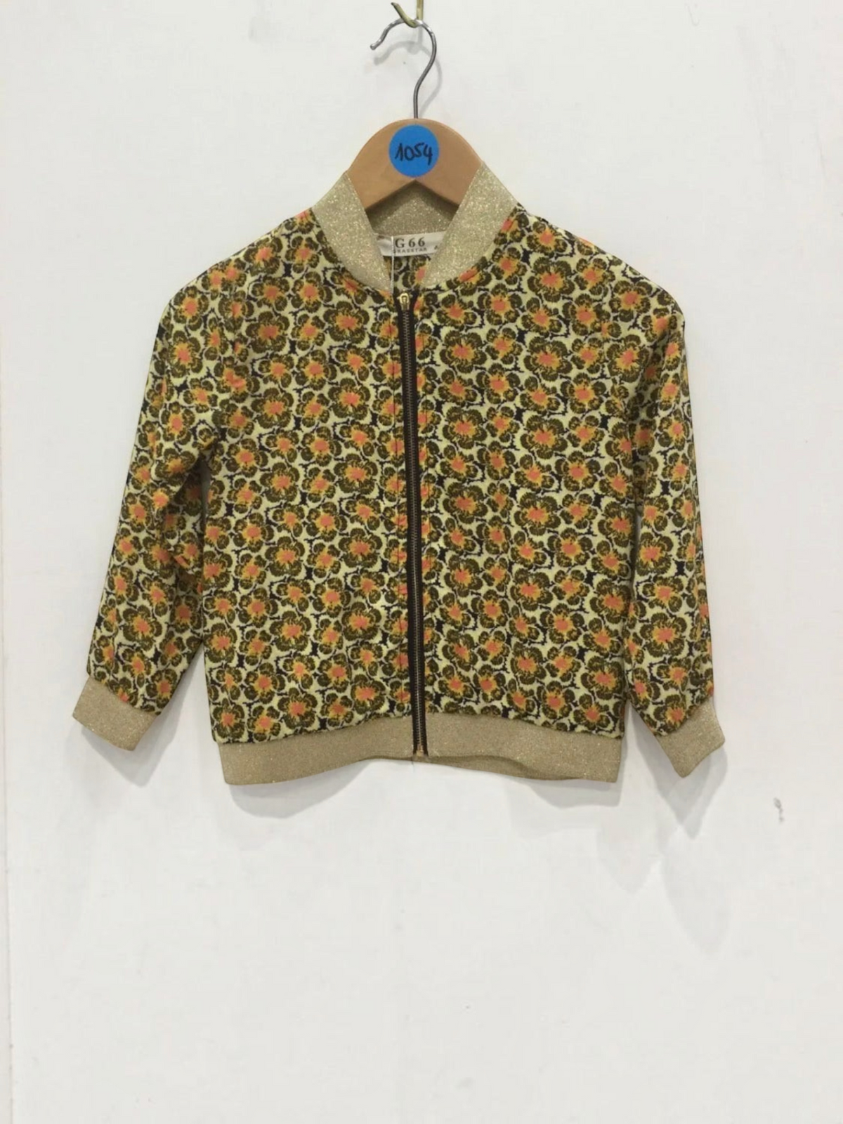 BROCK GRASSTAR kids bomber jacket featuring a vintage floral pattern in orange and brown with gold glitter trim.