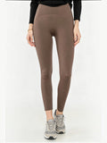 BROCK high-waisted brown elastic polyamide yoga leggings with a slim fit, worn by a model with grey sneakers.