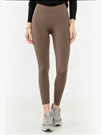 BROCK high-waisted brown elastic polyamide yoga leggings with a slim fit, worn by a model with grey sneakers.