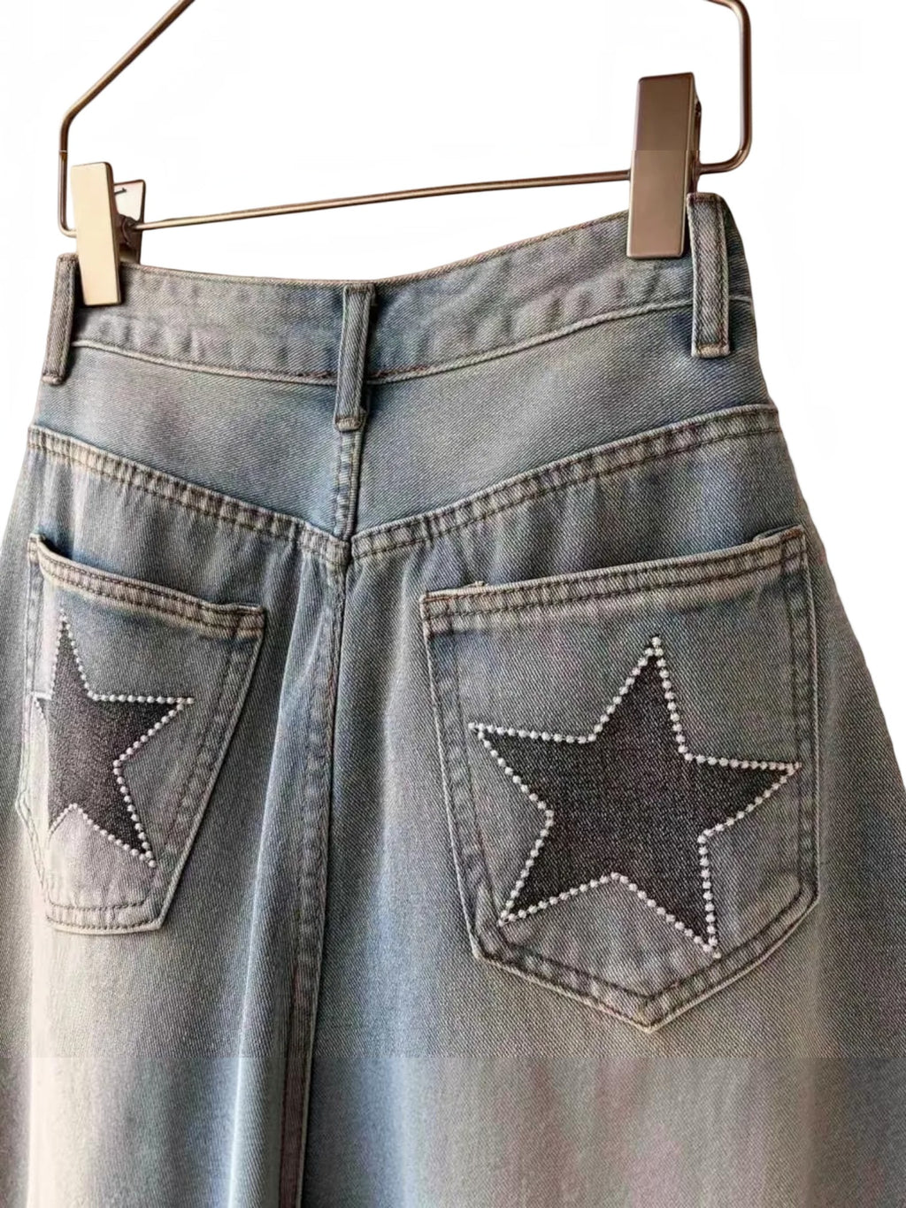 BROCK high-waisted denim skort in light blue cotton with star-detailed back pockets and stitched finishes.