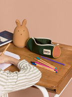 BROCK HINDBAG Mia tricolour pencil case in sage green on a wooden desk with a rabbit lamp and school supplies