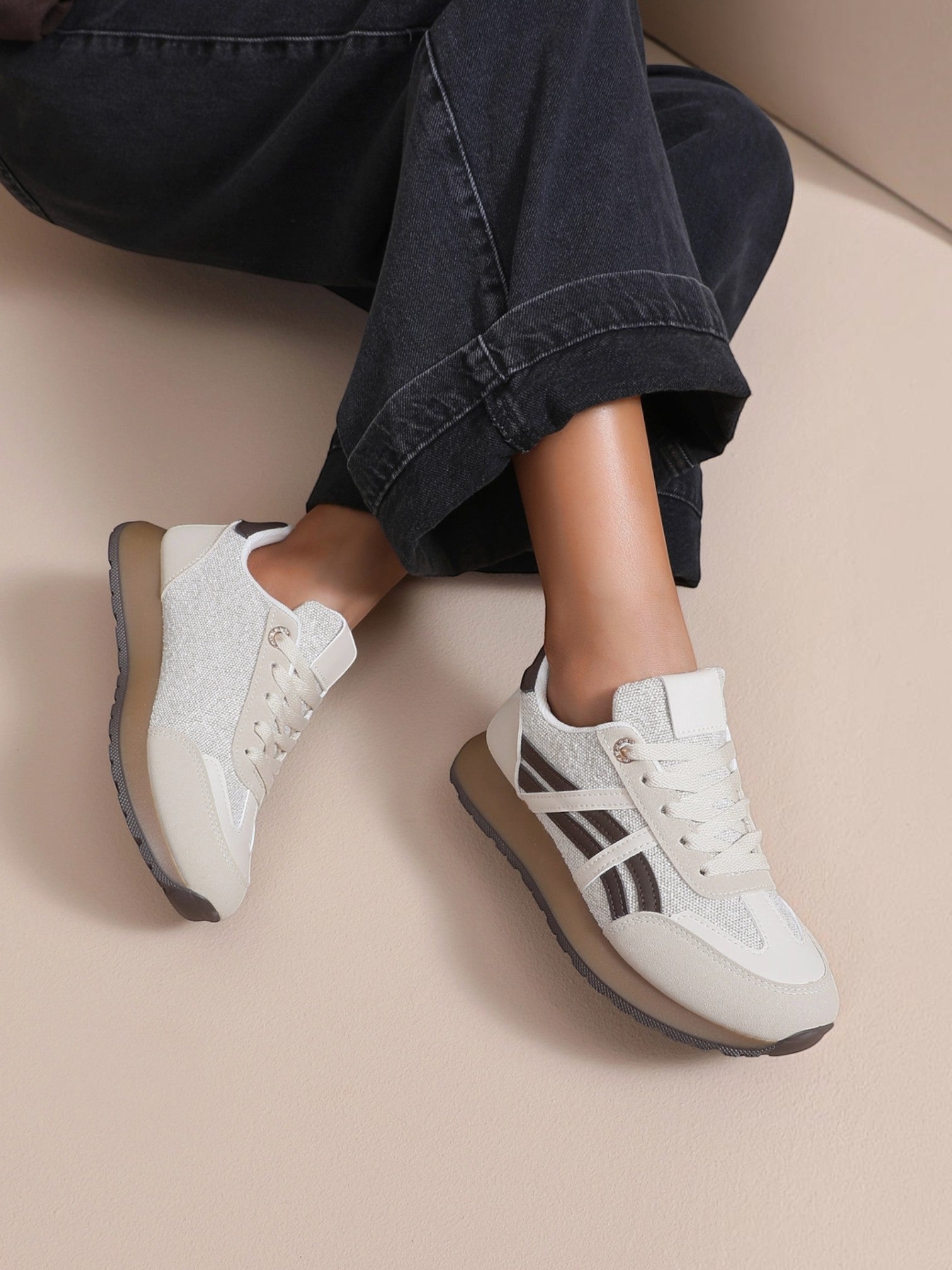 BROCK JOIA women's beige running lifestyle sneakers with contrasting panels and a lightweight sole worn with jeans