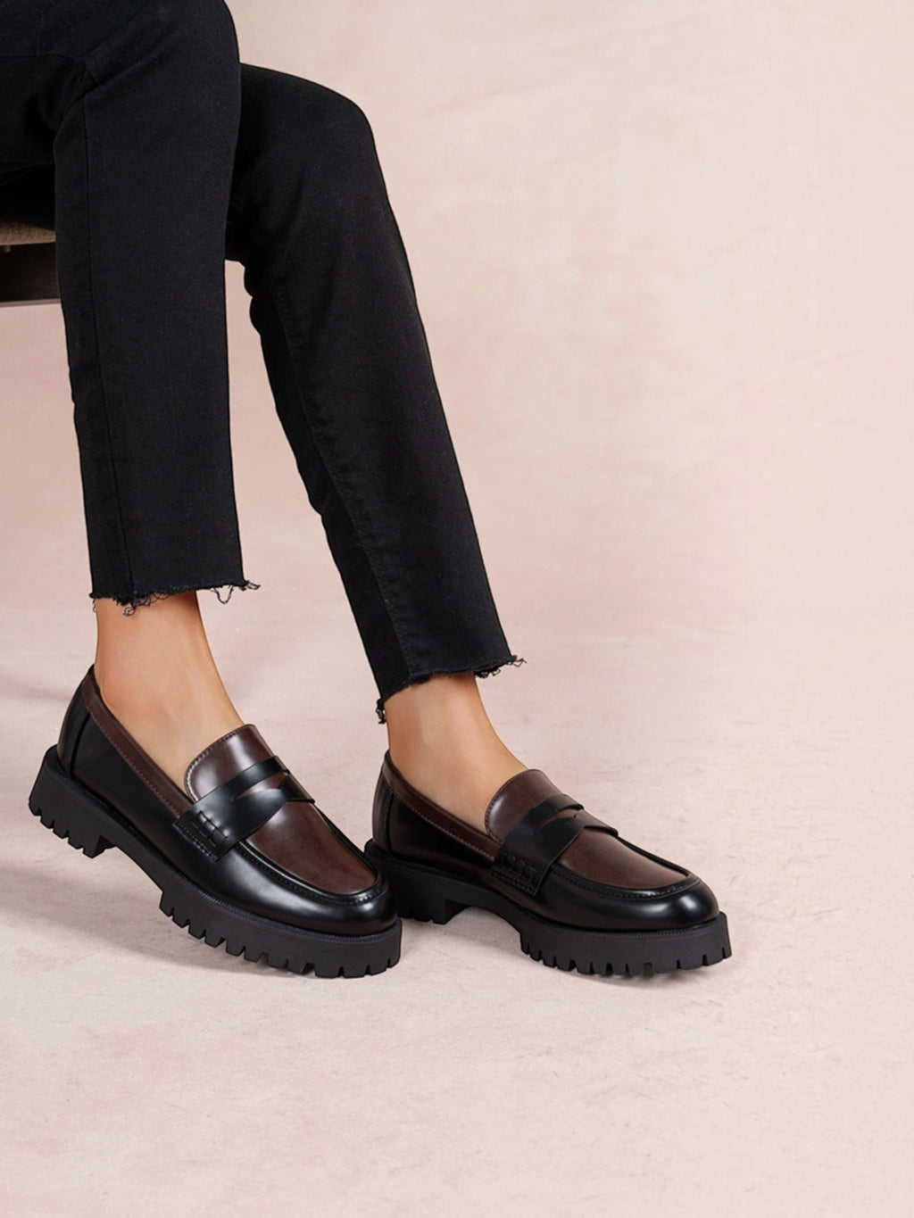 BROCK LADY GLORY two-tone chunky loafers in black and brown faux leather with a thick lug sole worn with black jeans