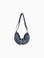 BROCK LINETA denim effect crossbody bag with a crescent shape and drawstring detail in a casual blue wash