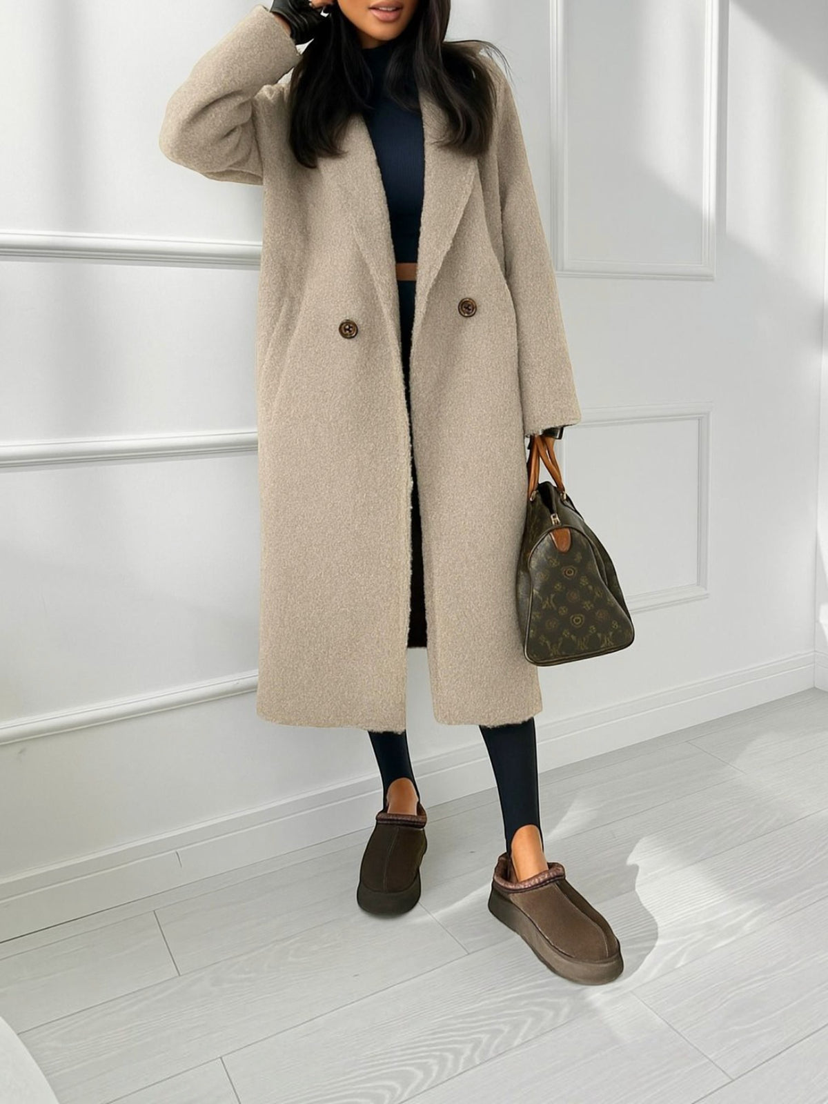 BROCK long beige bouclé coat with double-breasted buttons and side pockets worn over black leggings