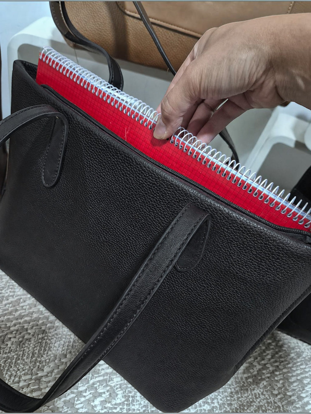 BROCK MIA LAROUGE black pebbled leather university shoulder bag with a red spiral notebook inside