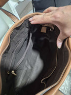 Interior view of a BROCK MIA LAROUGE tan leather university shoulder bag showing multiple storage compartments