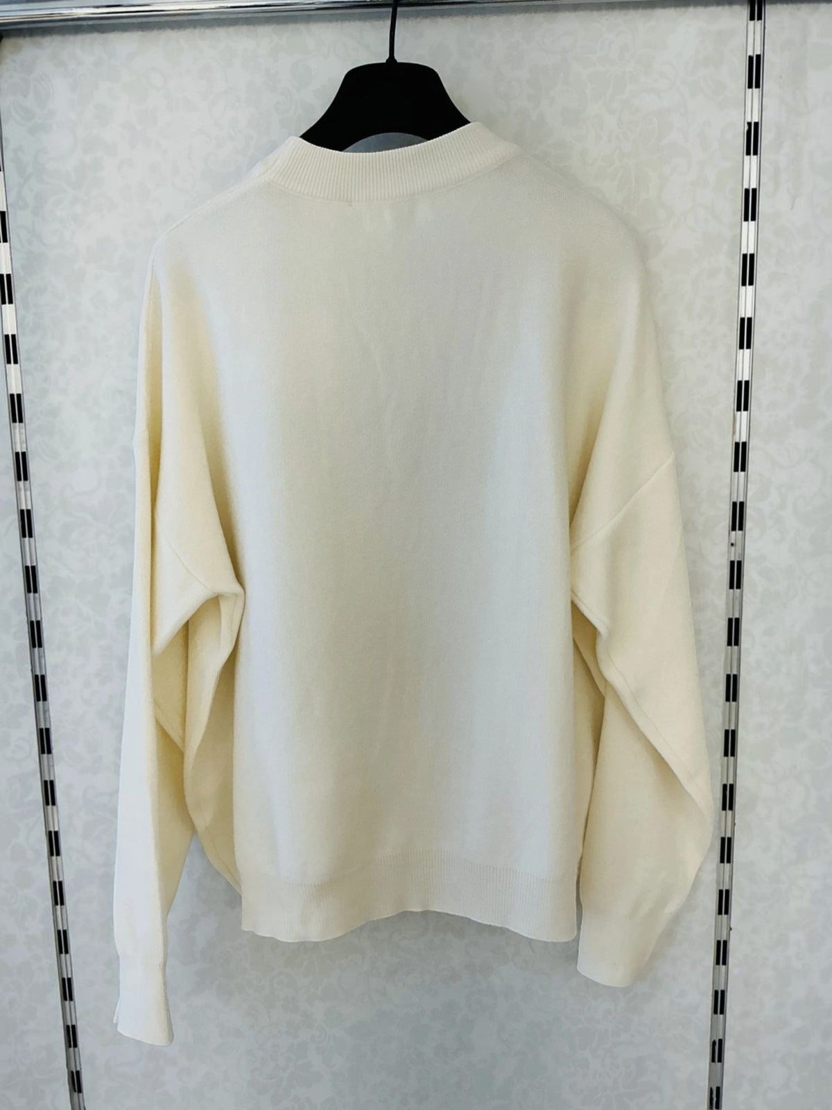 BROCK MISS CHARM beige cotton knit sweater with a round neck and long sleeves hanging on a hanger