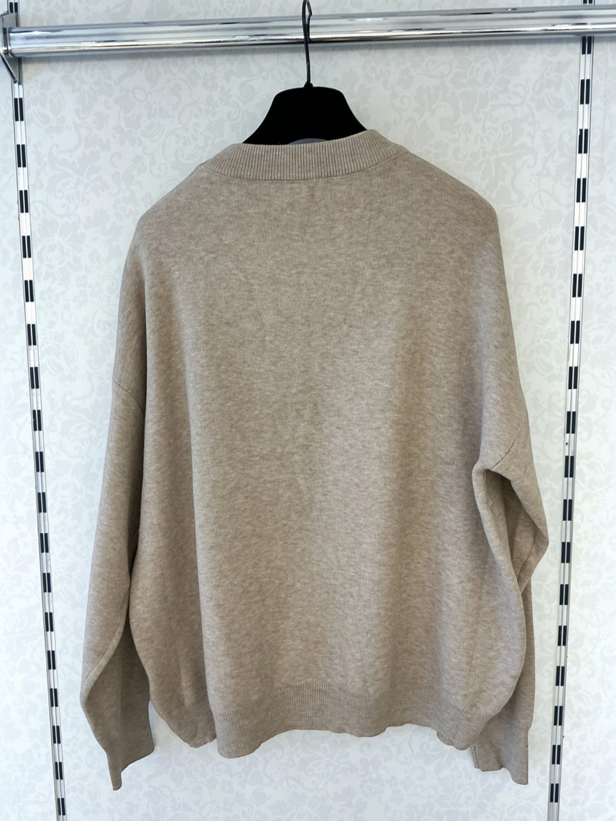 BROCK MISS CHARM beige cotton knit sweater with round neck and long sleeves hanging on a hanger