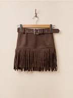 BROCK MOOYA brown faux suede mini skirt with fringe hem and matching belt with silver buckle hanging on a hanger