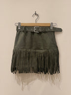 BROCK MOOYA olive green faux suede mini skirt with fringe hem and matching belt with silver buckle on a hanger