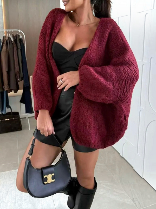BROCK oversize burgundy knit cardigan with long sleeves worn over a black top and leather shorts