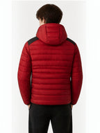 Back view of a man wearing a BROCK red quilted hooded jacket with black shoulder panels and horizontal stitching.