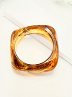 BROCK ROSA square resin bangle in translucent amber with golden inclusions and a polished finish