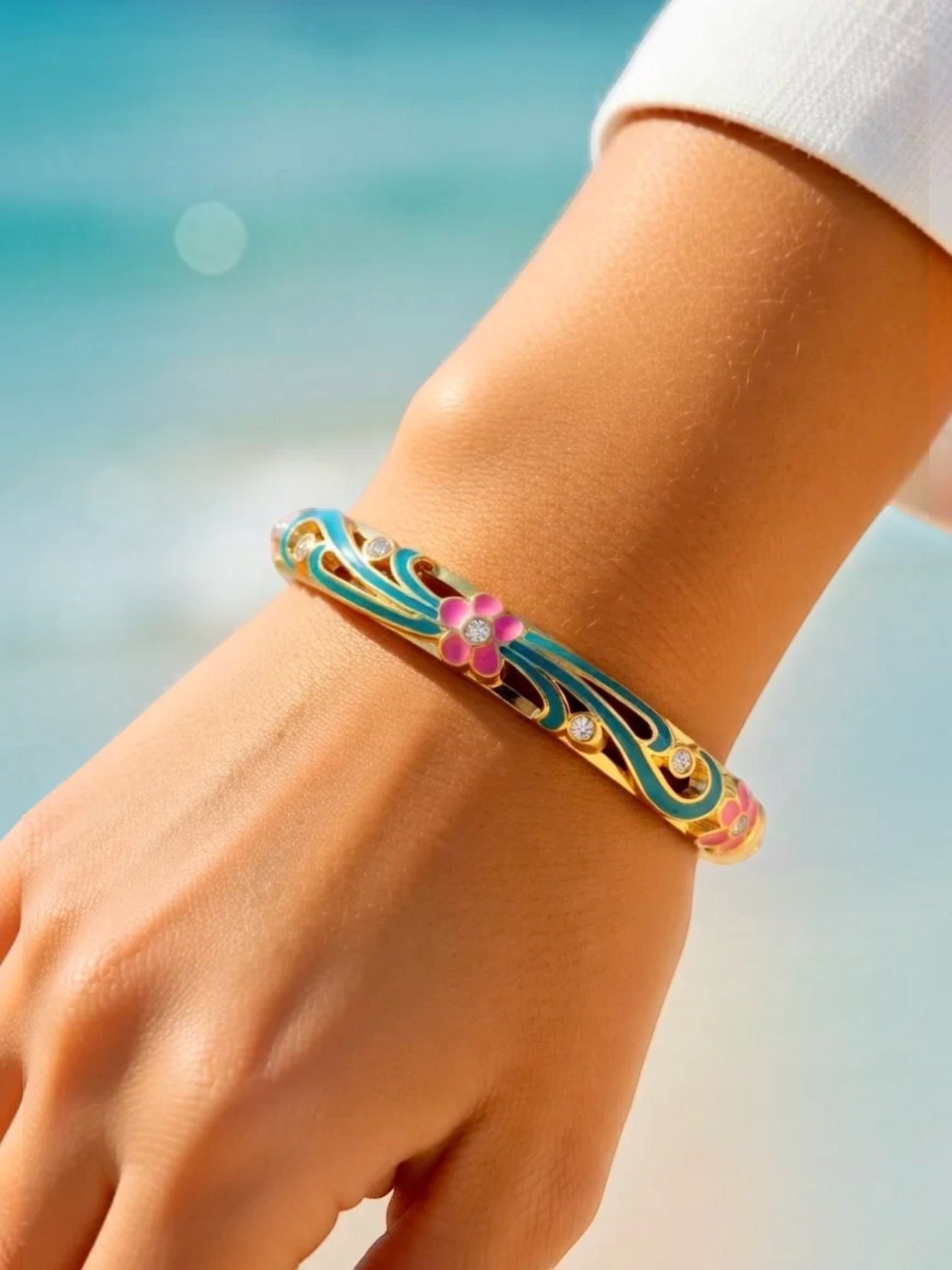 BROCK ROSA Thai-inspired brass bangle bracelet featuring pink floral enamel, turquoise accents, and crystal details.