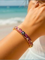 BROCK ROSA Thai-inspired brass bangle bracelet with purple and blue enamel floral details on a woman's wrist