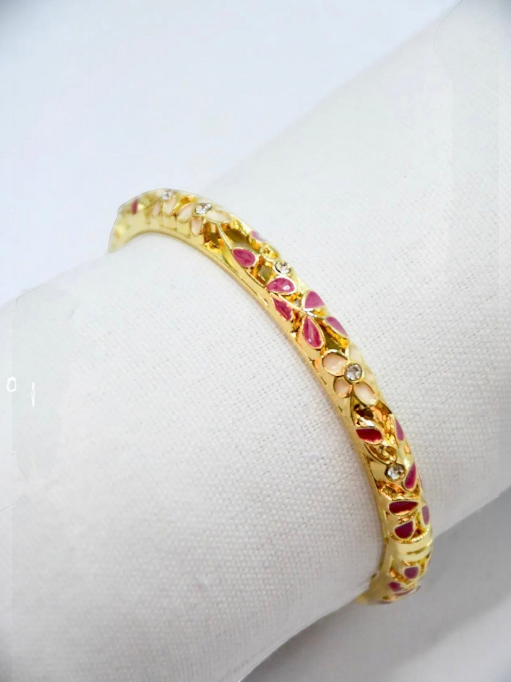 BROCK ROSA Thai-inspired brass bangle bracelet with pink and white floral enamel detailing and crystal accents.