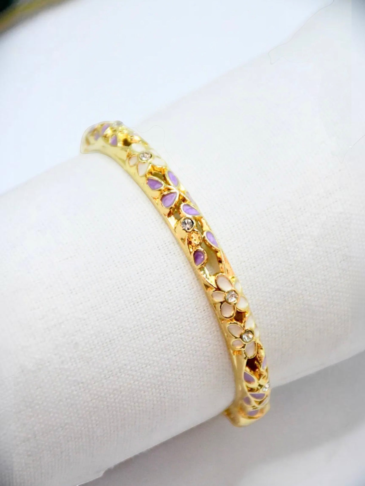 BROCK ROSA Thai-inspired brass bangle bracelet featuring delicate floral enamel patterns and embedded crystals.