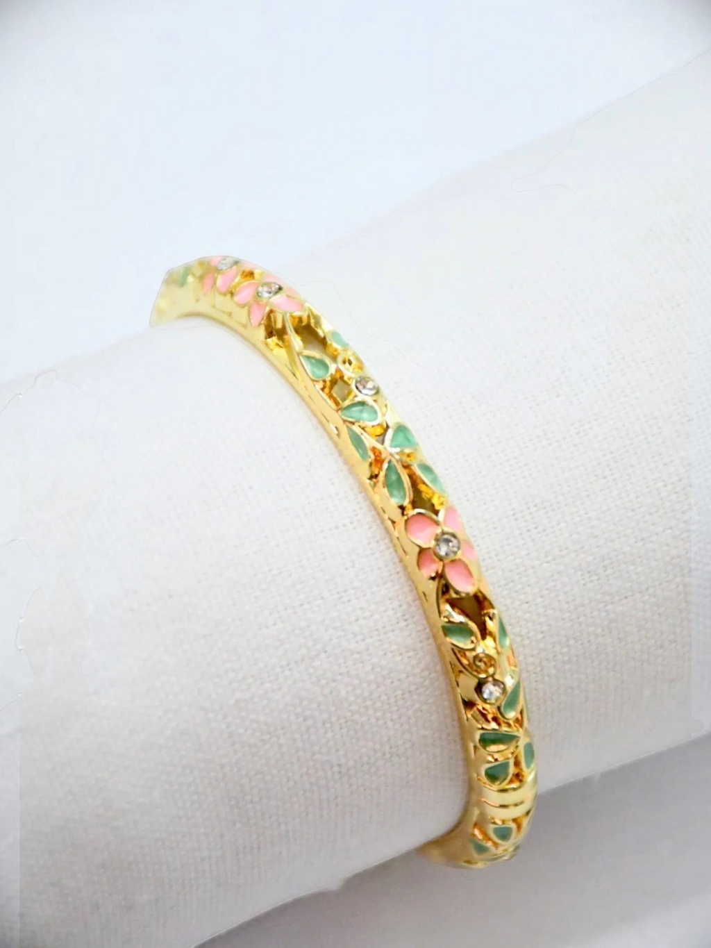 BROCK ROSA Thai-inspired gold brass bangle bracelet with delicate pink and green floral enamel and crystal accents.