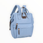 Sac à dos Métropole GALLANTRY bleu clair en toile avec détails en cuir marron, idéal pour le travail ou les études.