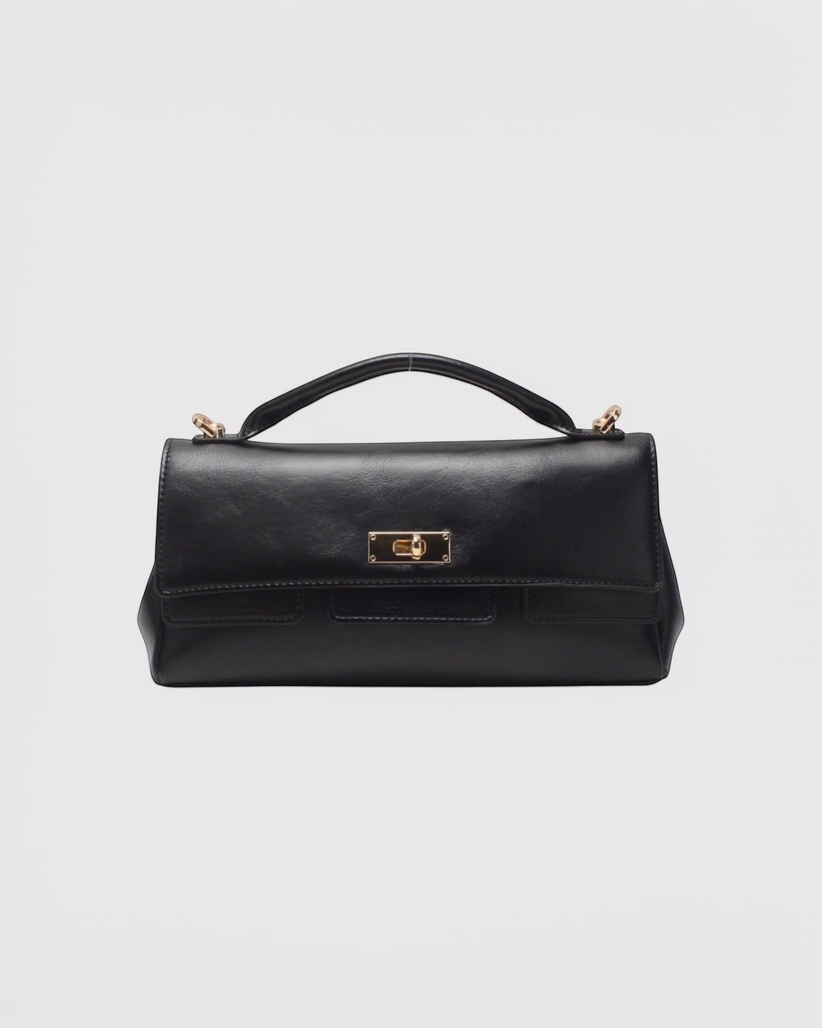 Sac baguette noir BESTINI en cuir avec fermoir tourniquet doré et poignée supérieure. Polyvalent et chic.