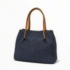 Sac à main bleu marine en raphia avec garnitures en cuir marron de la marque BROCK, anses en cuir marron.