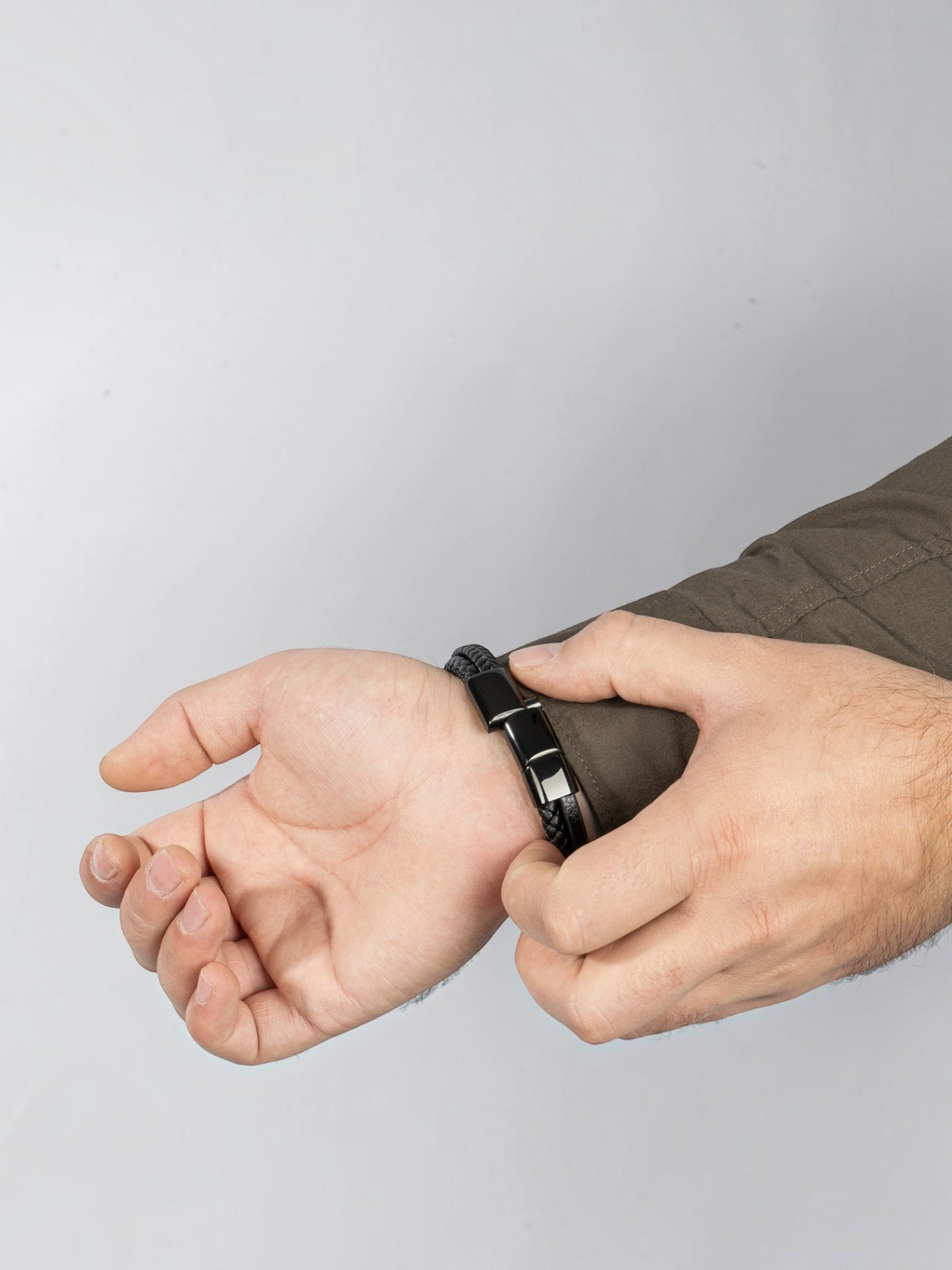 BROCK SERASAR black leather bracelet with stainless steel magnetic clasp worn on a man's wrist