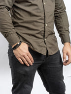 BROCK SERASAR black leather bracelet with stainless steel magnetic clasp worn on a man's wrist