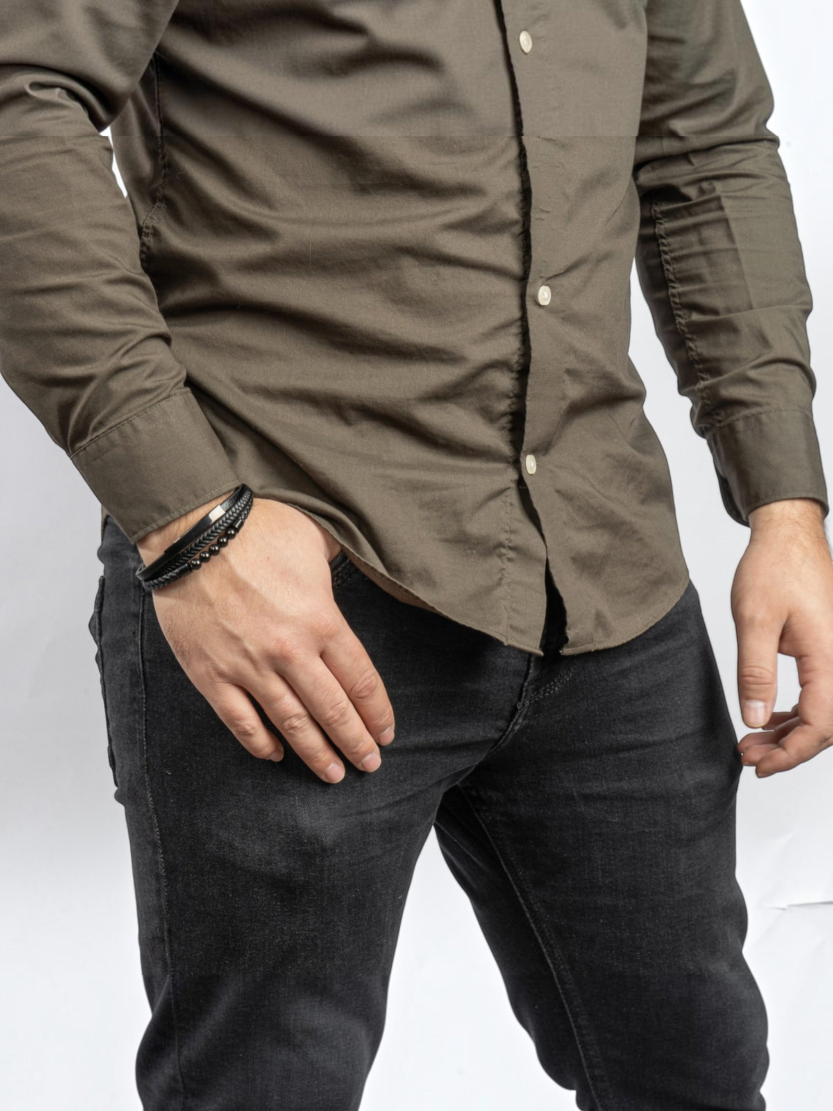 BROCK SERASAR black leather bracelet with stainless steel magnetic clasp worn on a man's wrist