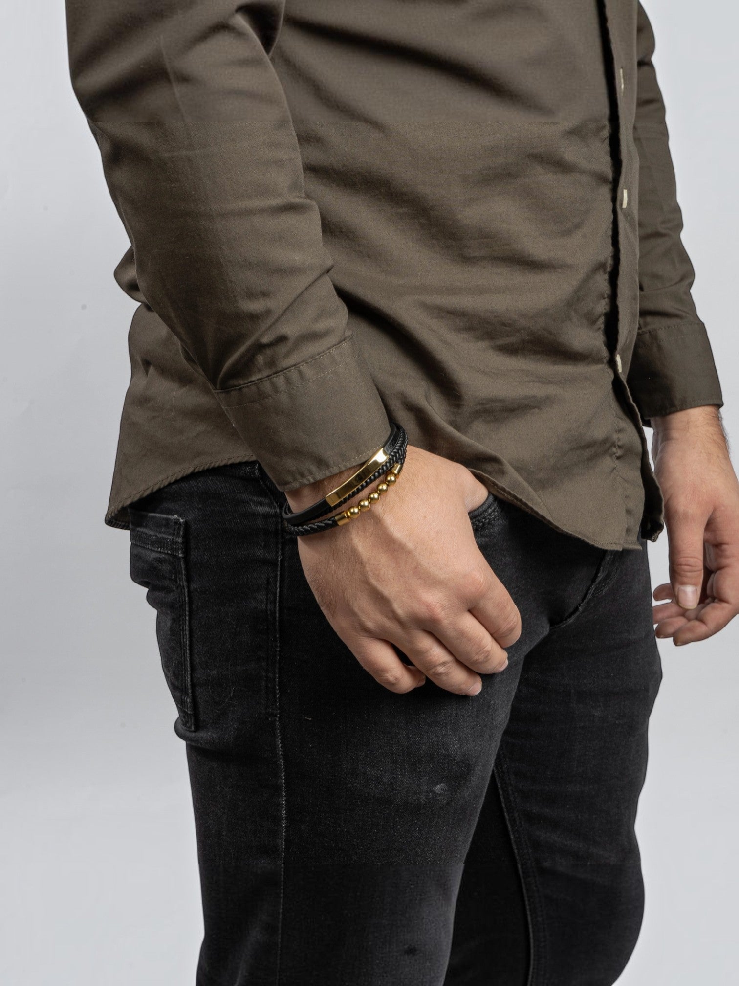 BROCK SERASAR black leather bracelet with gold stainless steel magnetic clasp worn on a man's wrist